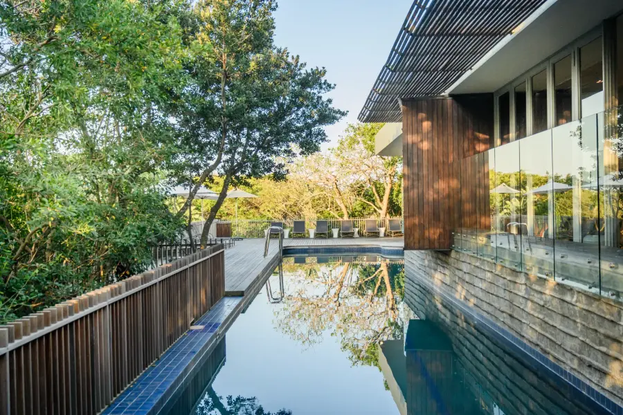 The outdoor pool and its timber deck at dusk