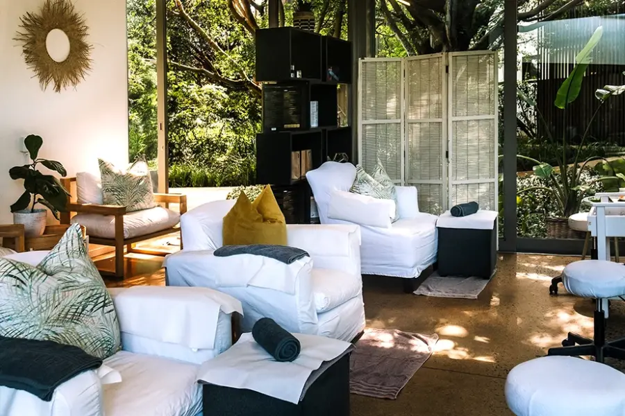 The Laura Channing Spa lounge, white seating opening onto the garden