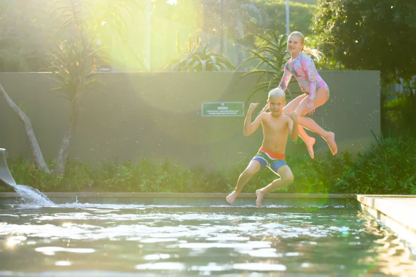 Kids leaping into the pool