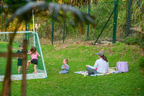 A family afternoon on the lawn, five-a-side goals and a picnic blanket
