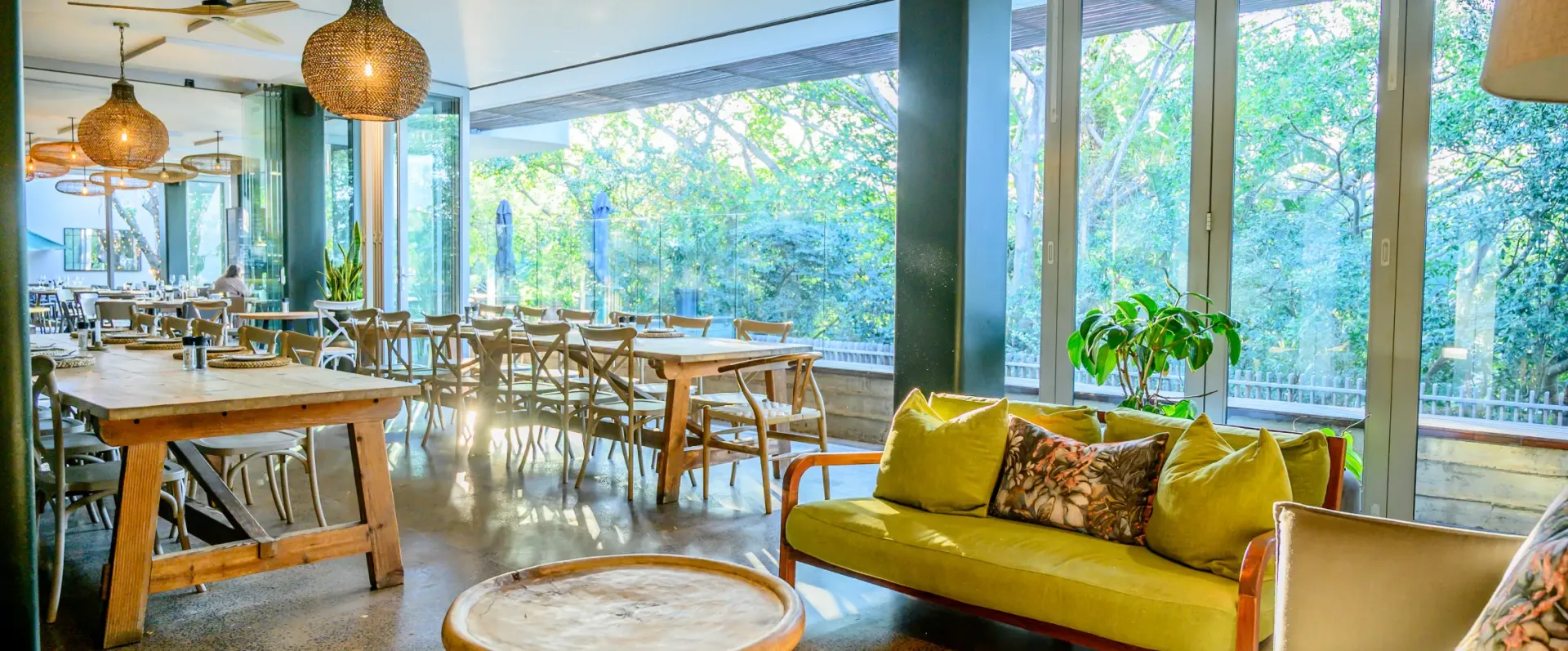 The clubhouse lounge looking out through full-height windows into the forest