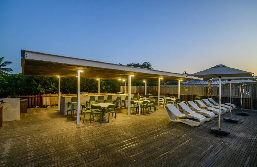 Tables on the covered clubhouse deck at dusk